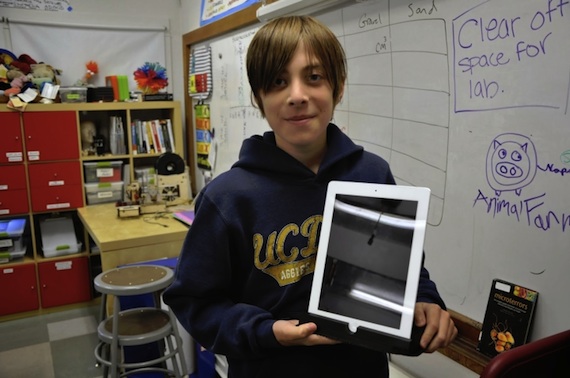 Student Cole Compton holds a partially printed iPad stand. (Photo courtesy of Christine Mytko.)