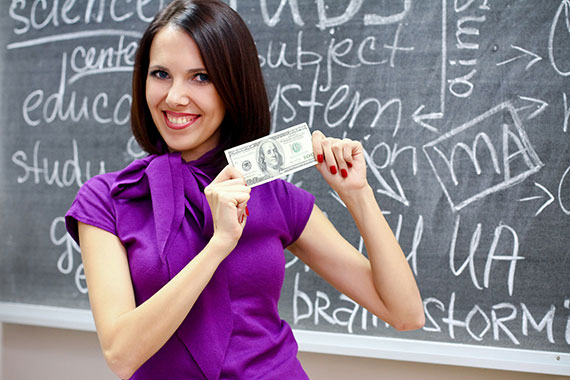 Teacher smiling, holding money