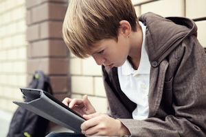 kid with tablet at school
