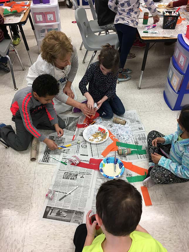 Kindergartners in Loudoun County work on games designed to stimulate the minds of orangutans.