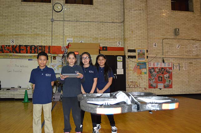Jersey City Public Schools students fly drones indoors.