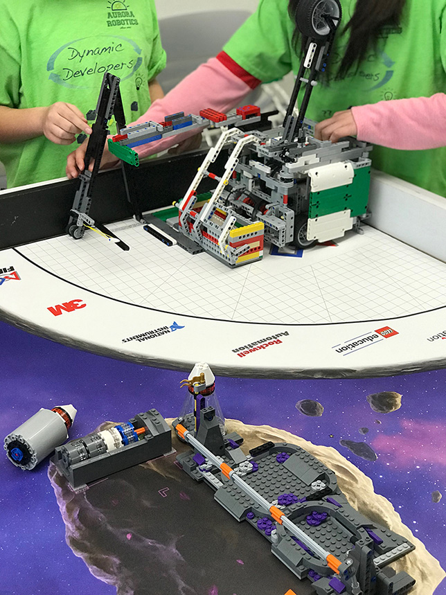During the open house for the Urban STEM Education Center, student members of an area robotics club demonstrated a robot made out of Legos as part of the First Lego League, a competition for elementary and middle school students. Source: Urban STEM Education Center.