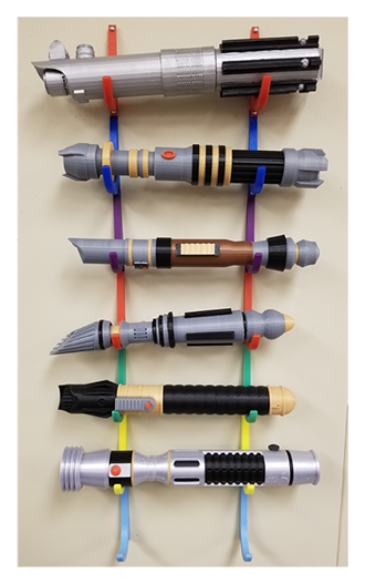 Lightsabers hang on a classroom wall, all designed by students using Tinkercad and printed on a 3D printer.
