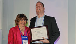 simCEO founder Derek Luebbe accepts innovation incubator award from Karen Billings from SIIA