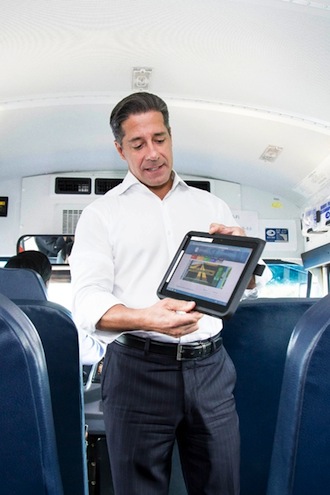 Miami-Dade County Public Schools Superintendent Alberto Carvalho shows Wi-Fi-on-the-Go on a district-owned school bus.