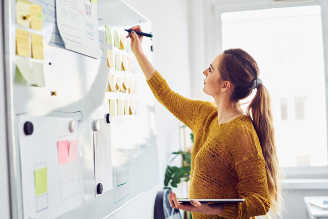 teacher writing on whiteboard in office