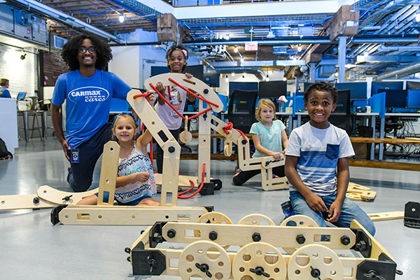 Children posing with Rigamajig sets