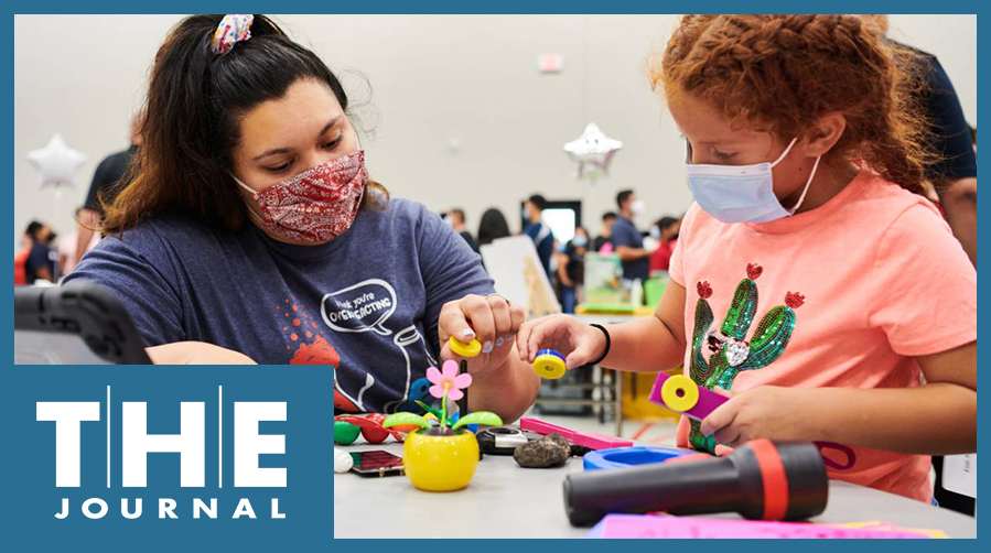 An adult helps a child with a hands-on learning project during a Verizon Innovative Learning program