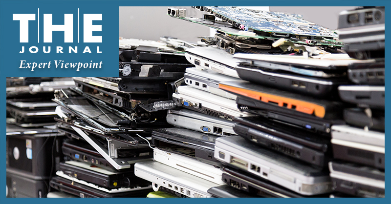 image shows stacks of old laptops in various states of disrepair
