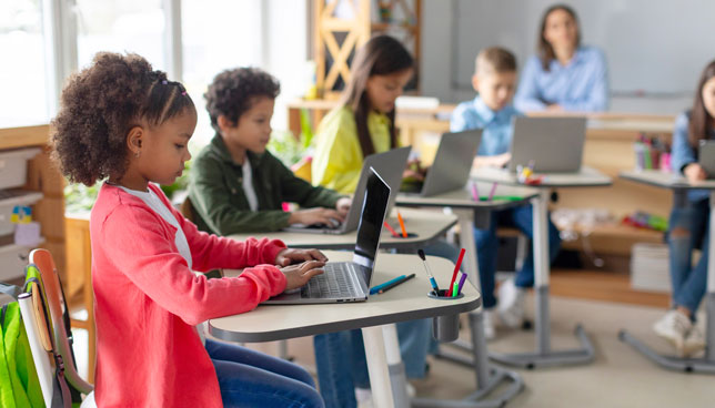 kids using laptops in a classroom