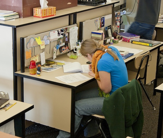 student at her desk in one of the pod workstations