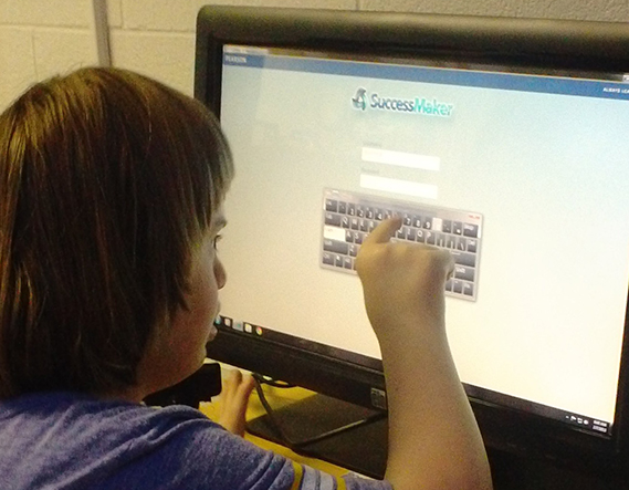 Student at a touchscreen computer in a multimodal communications classroom