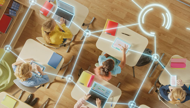 Top View: Children in a School Use Tablets and Laptops to Study