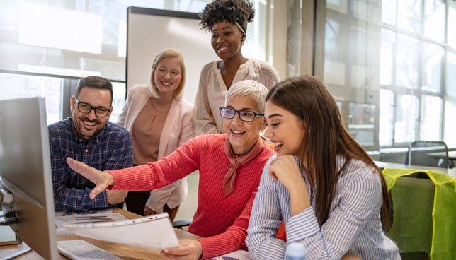 group of educators working on computer