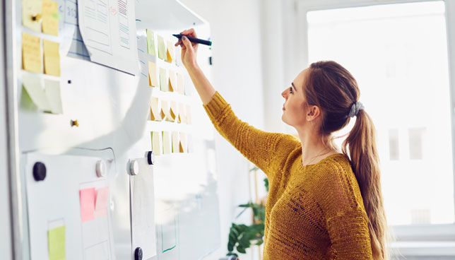 teacher writing on whiteboard in office