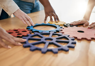 Hands and gears with a business team working together